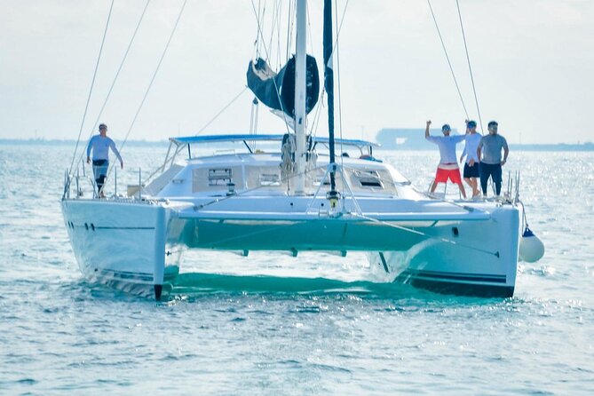Splendid Isla Mujeres Catamaran: drinks and fun all day! - Onboard energy for the return: music, dancing, and golden-hour sea views