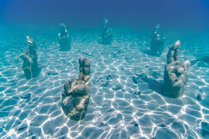 Trip to Isla Mujeres by Catamaran, with snorkeling and drinks - Onboard experience: crew focus, deck views, and the drink situation